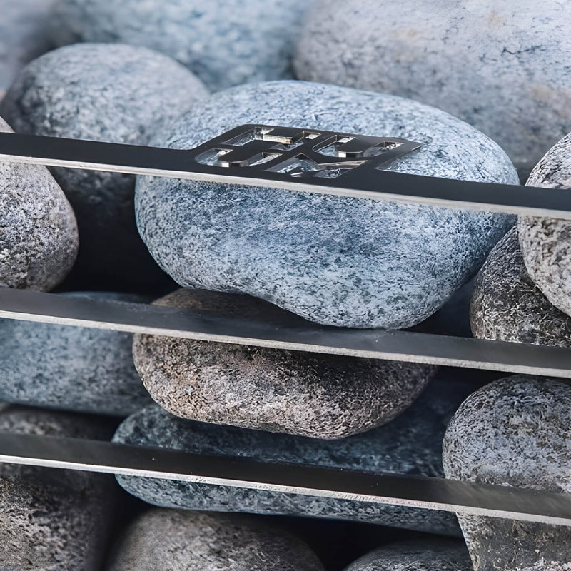 Close-up of a metal tool on pebbles with a blurred background