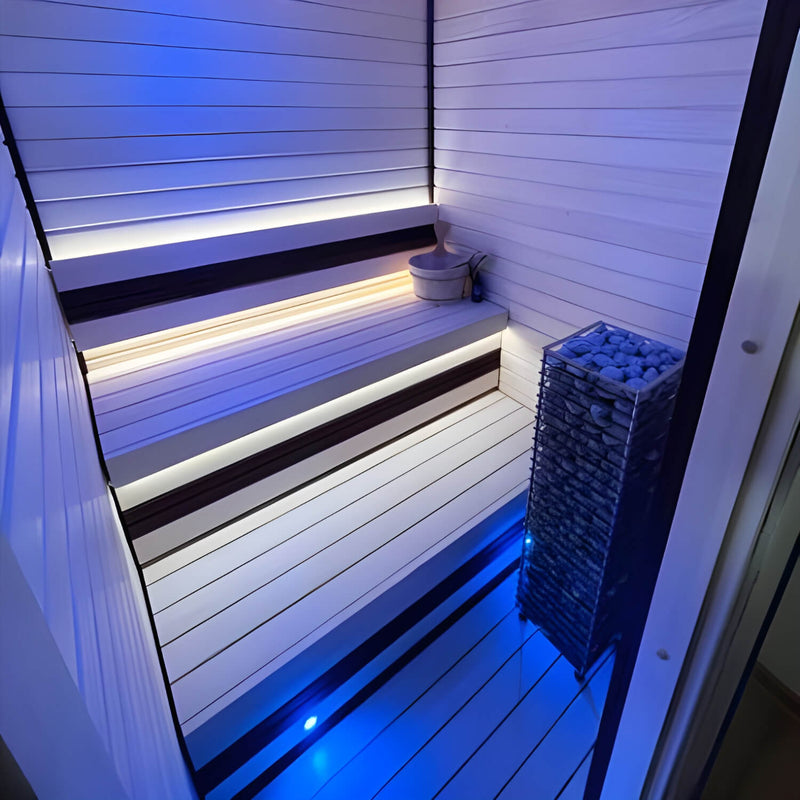 Infrared sauna with LED lighting and a basket of stones.