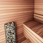 Wooden sauna interior with a bench, sauna heater, and heater stone rack.