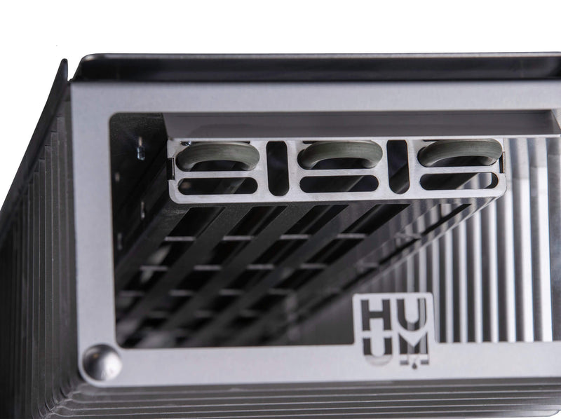 Close-up of a metal component with 'HUM' branding on a white background