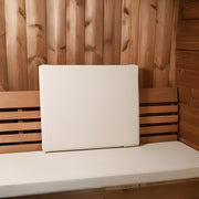 White cushion on a wooden bench with wooden wall background