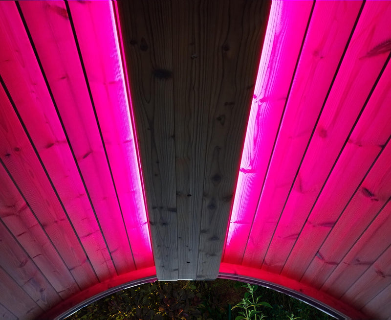 Wooden structure with pink LED lighting on a dark background