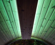 Wooden panel with green lighting on a wooden surface