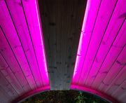 Wooden structure with pink LED lighting on a dark background
