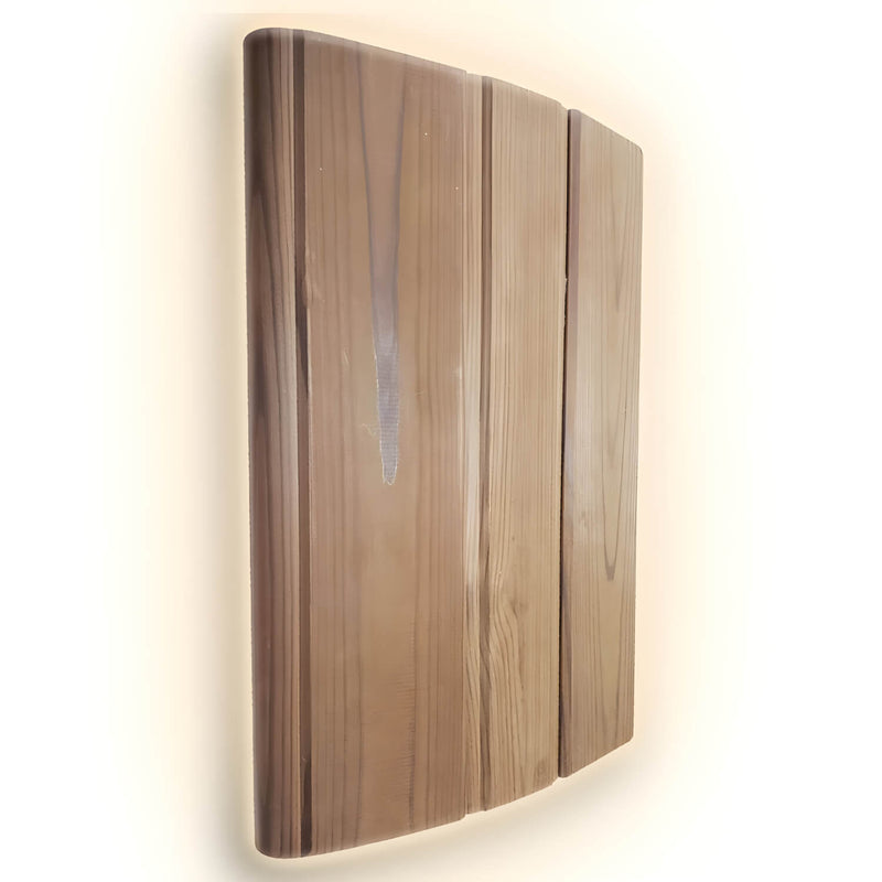Wooden wall-mounted light fixture with a warm glow on a white background