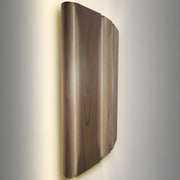 Wooden wall sconce with a warm glow on a gray background