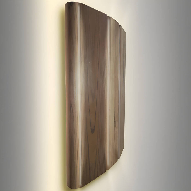 Wooden wall sconce with a warm glow on a gray background