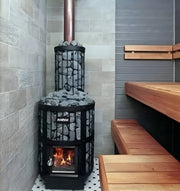 Wood-burning sauna heater in a tiled room with wooden benches.
